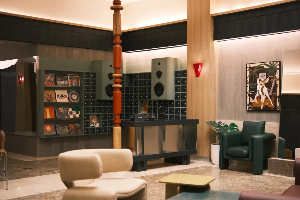 Hotel lobby with a record wall, a red carved column and armchairs